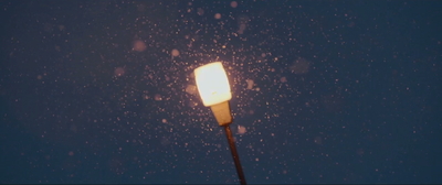 a street light in the snow at night