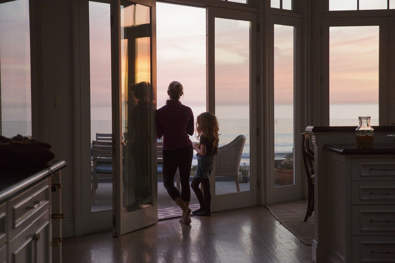 a man and a little girl standing in front of a door