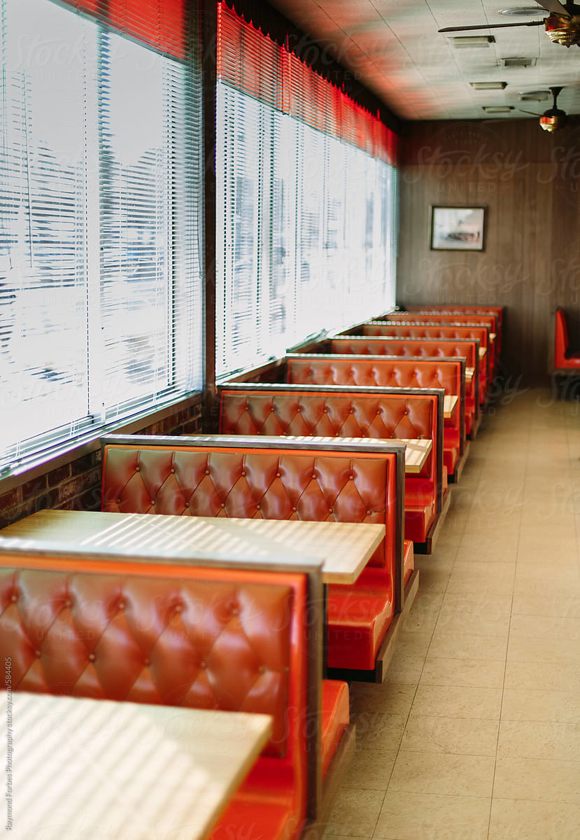 a row of red leather seats in a restaurant