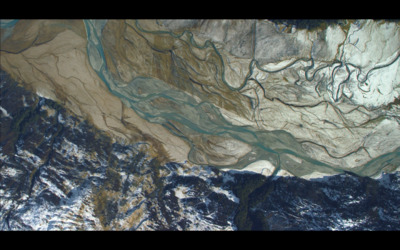 an aerial view of a river and mountains