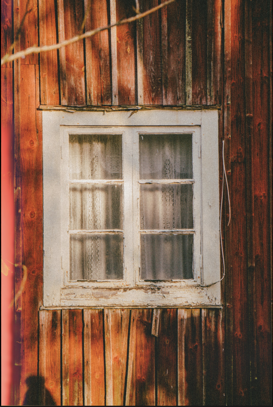 a window on the side of a wooden building