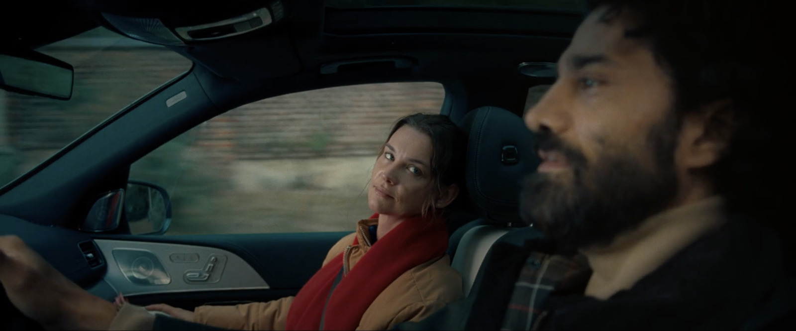 a man and a woman sitting in a car