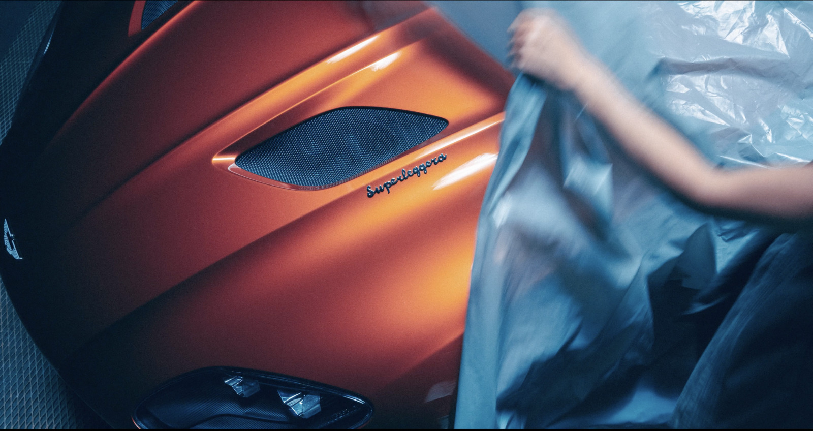 a woman is holding a plastic bag near a car