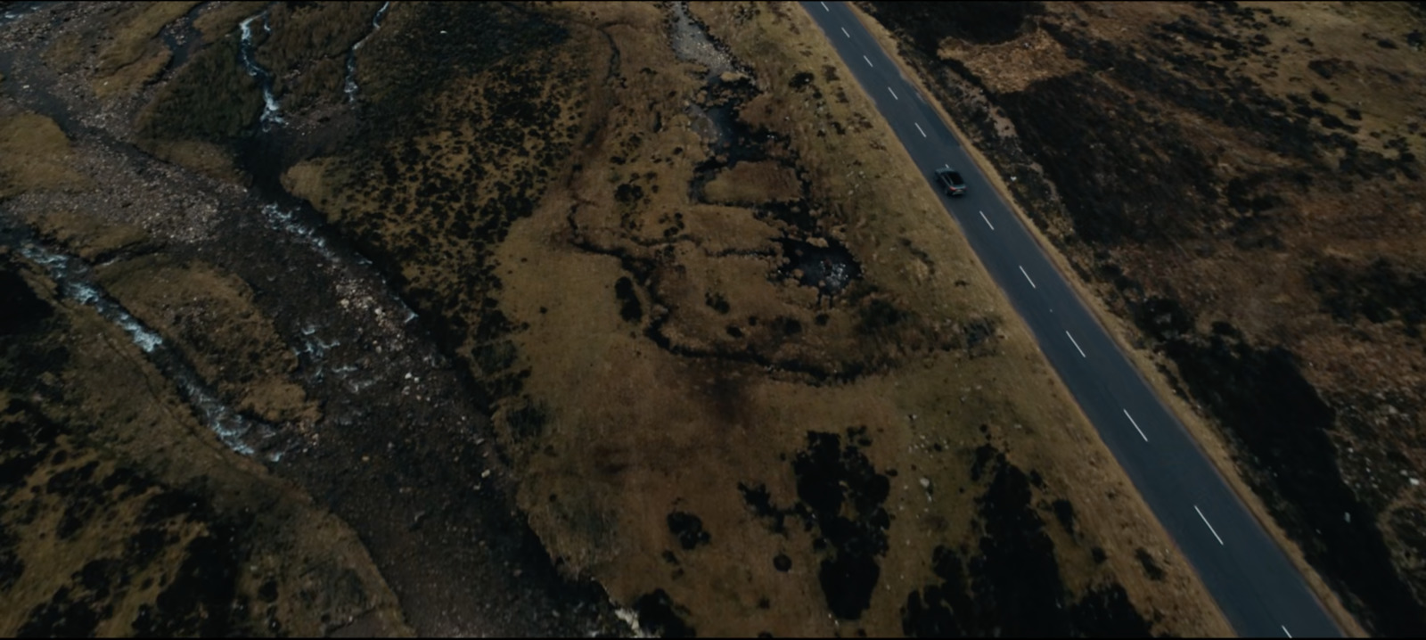 an aerial view of a road in the middle of nowhere