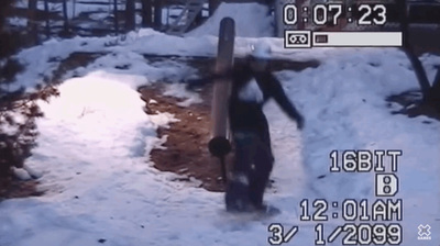 a man is walking through the snow with a snowboard