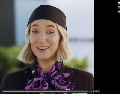 a woman with blonde hair wearing a black hat