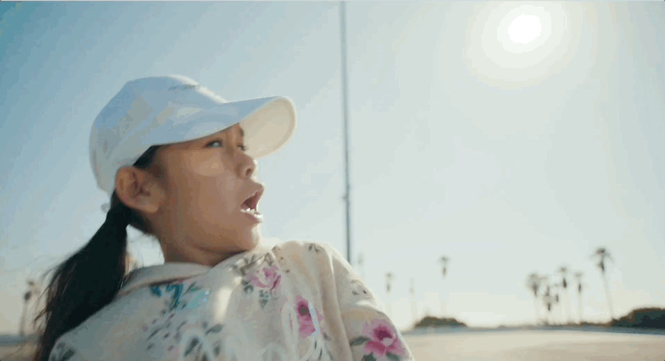 a woman wearing a white hat and a white shirt