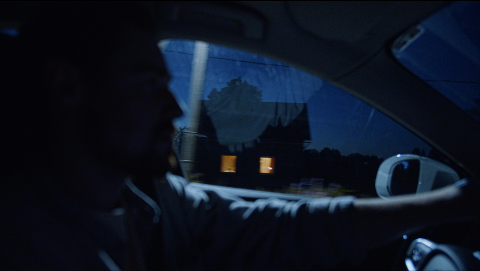 a man driving a car in the dark