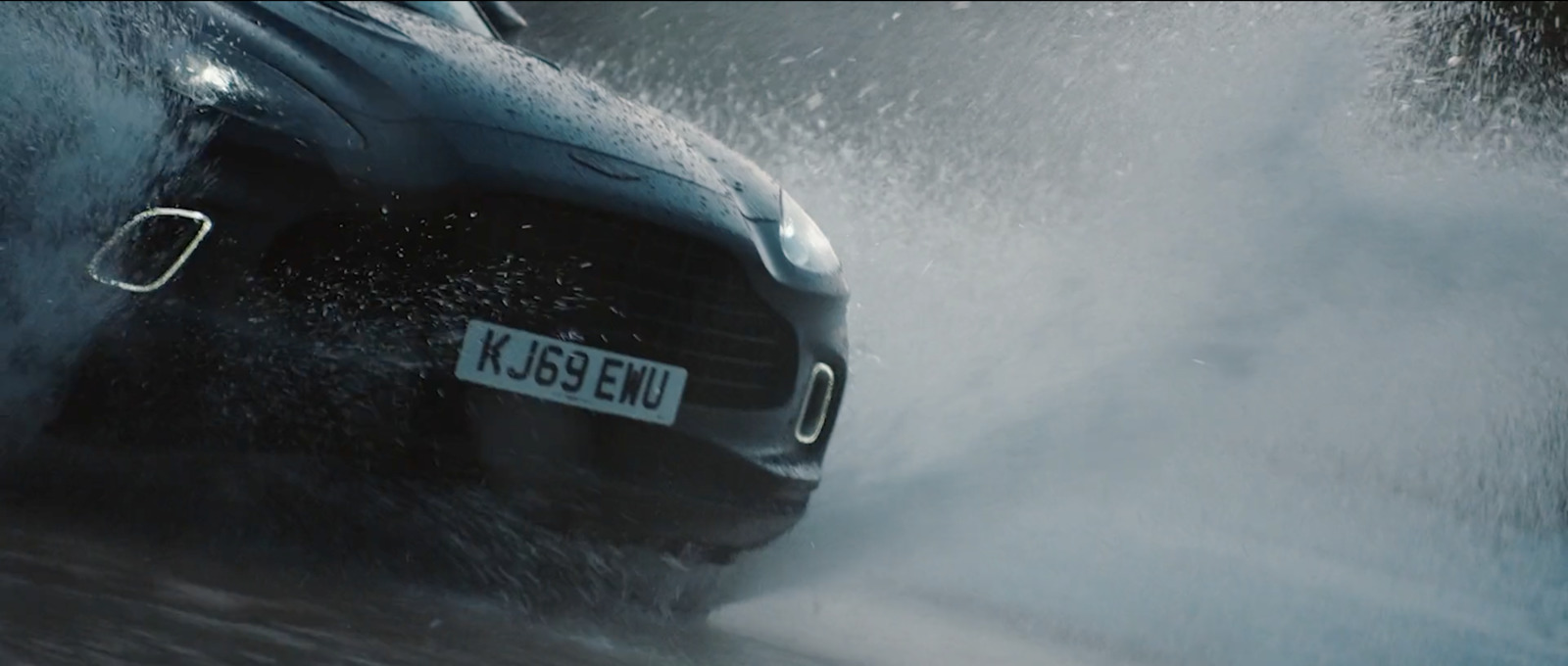 a car splashing through a body of water