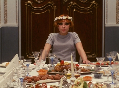 a woman sitting at a table with a plate of food