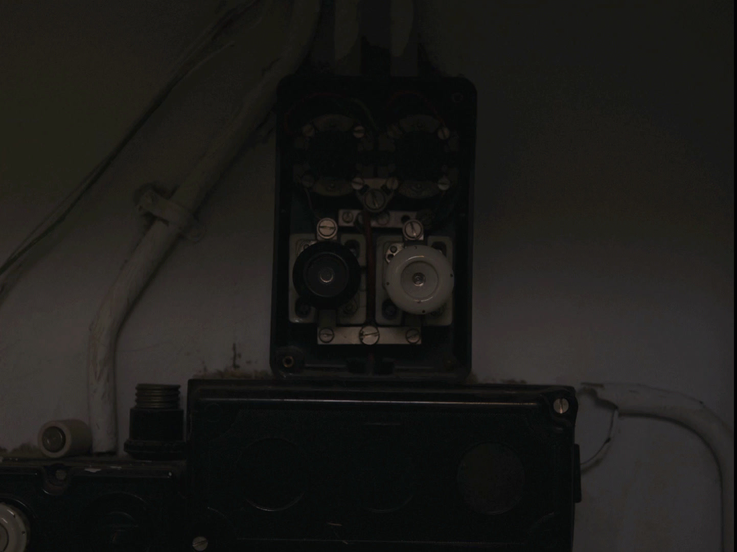 a black and white photo of a camera and some wires