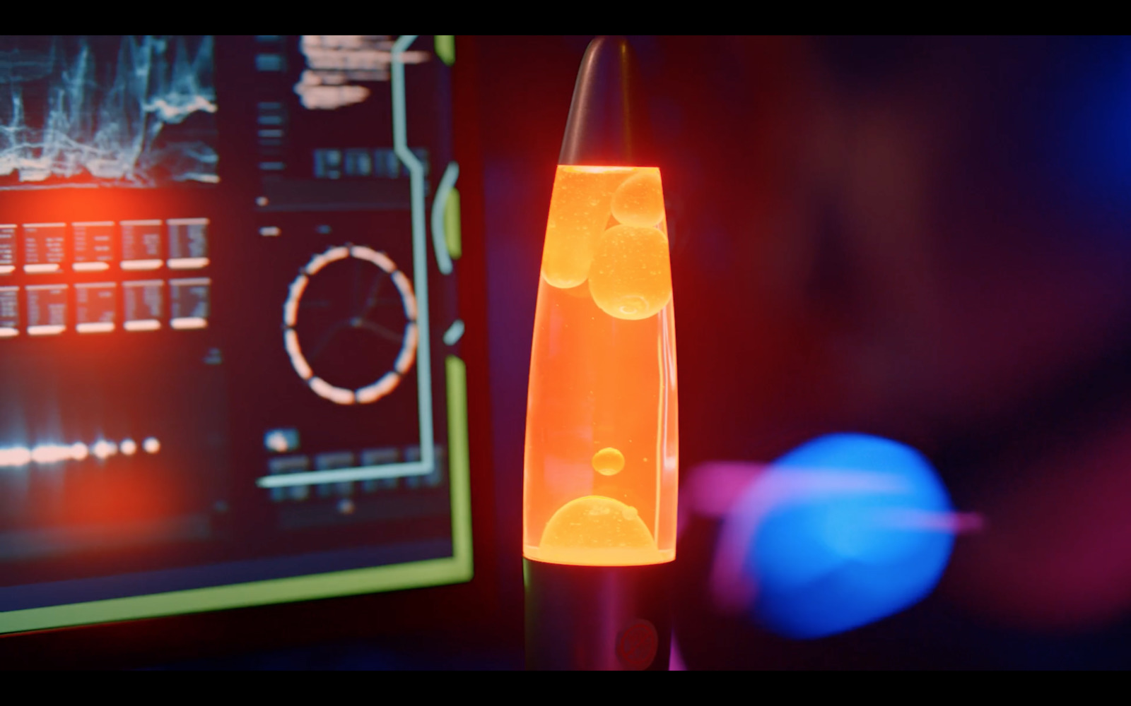 a close up of a lava lamp in front of a computer screen