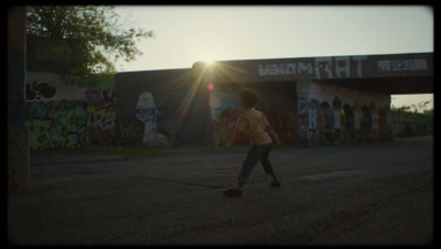 a person walking down a street with a skateboard