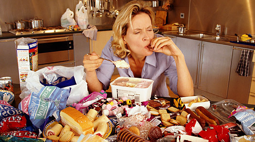 a woman sitting at a table full of food