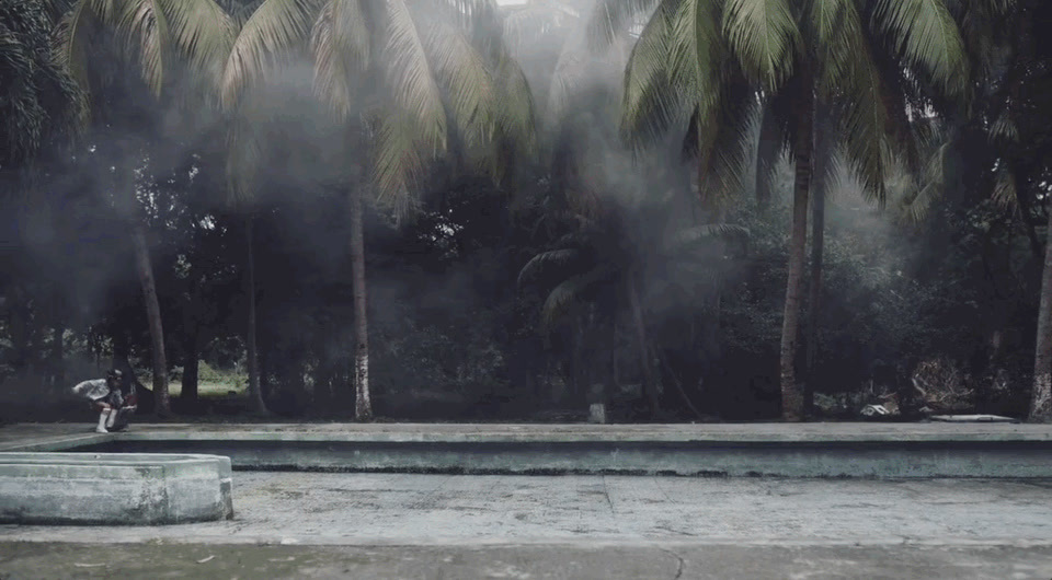 a man riding a skateboard on top of a cement slab