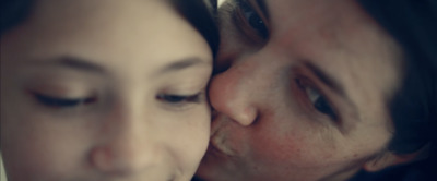 a close up of a person kissing another person