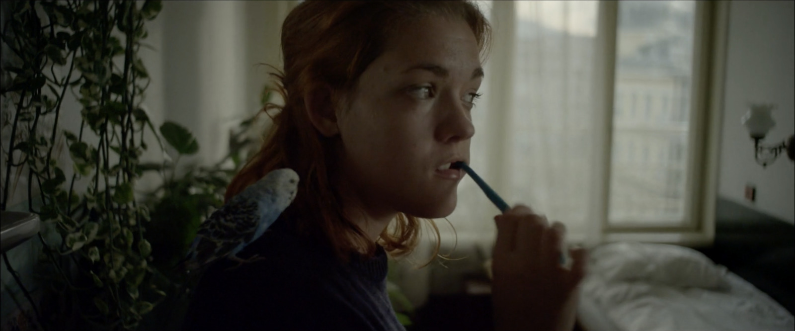 a woman brushing her teeth with a toothbrush
