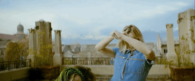 a woman standing next to another woman in a blue dress