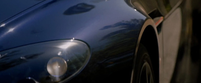 a close up of the front of a blue sports car