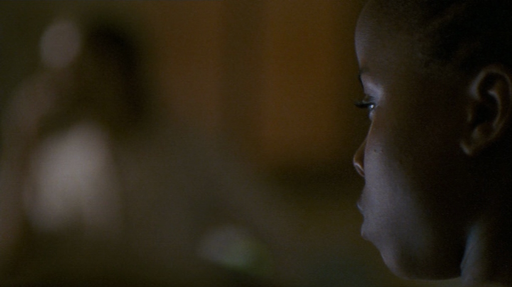 a close up of a child's face in the dark