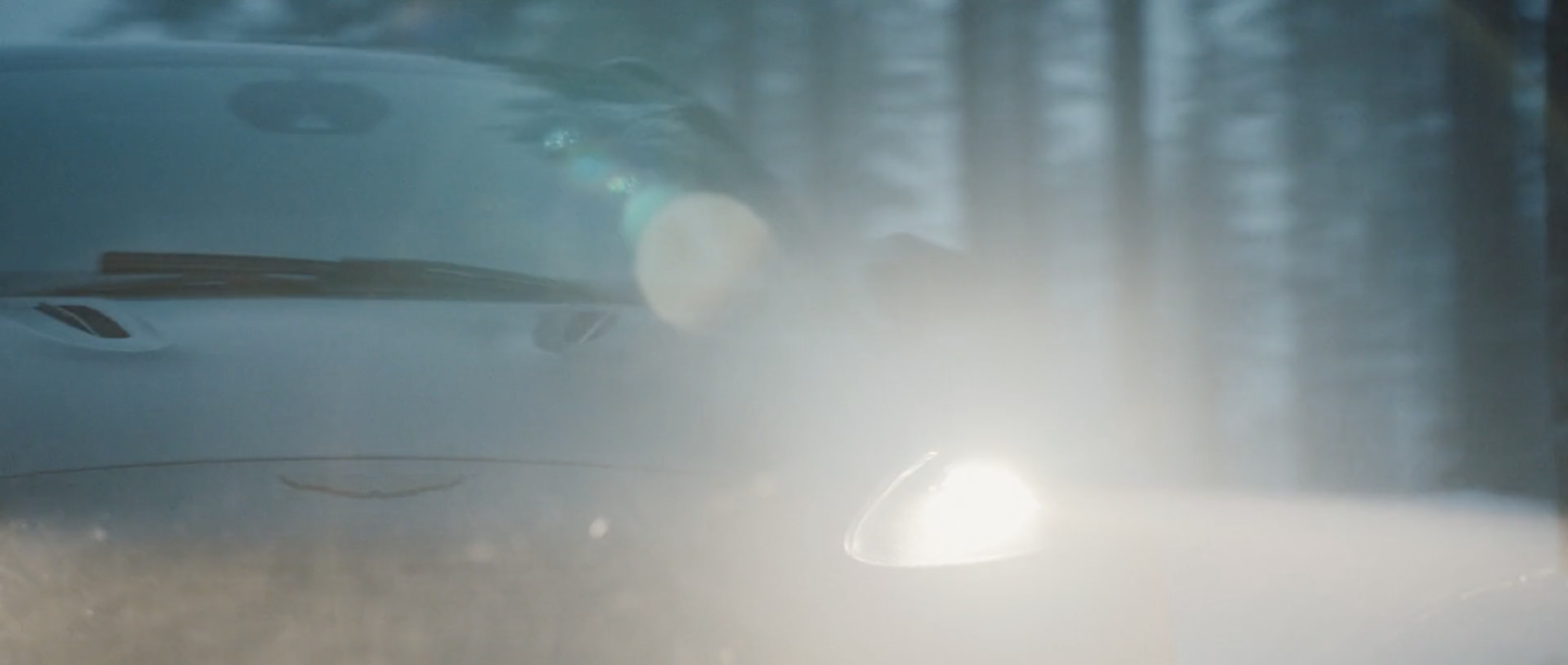 a car driving through a foggy forest