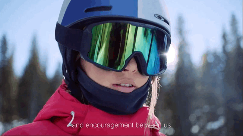 a woman wearing a helmet and goggles in the snow