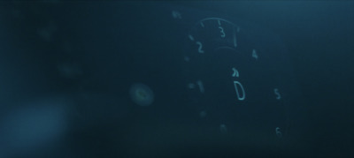 a close up of a clock in a dark room