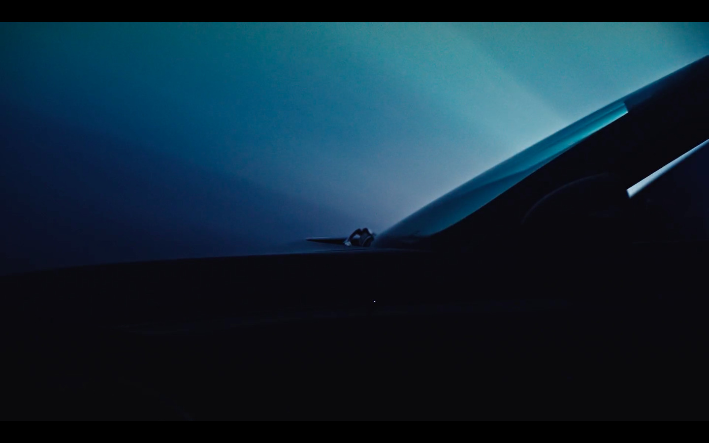 a car driving down a road at night