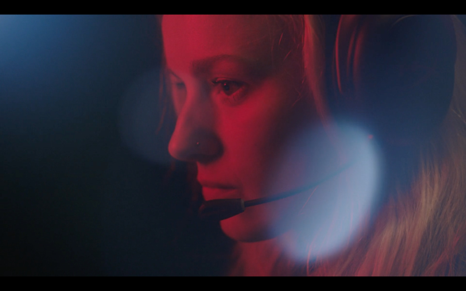 a woman wearing a headset in a dark room