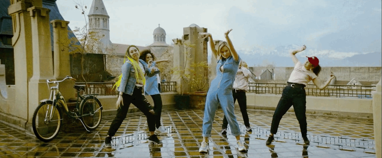 a group of people standing on top of a tiled floor