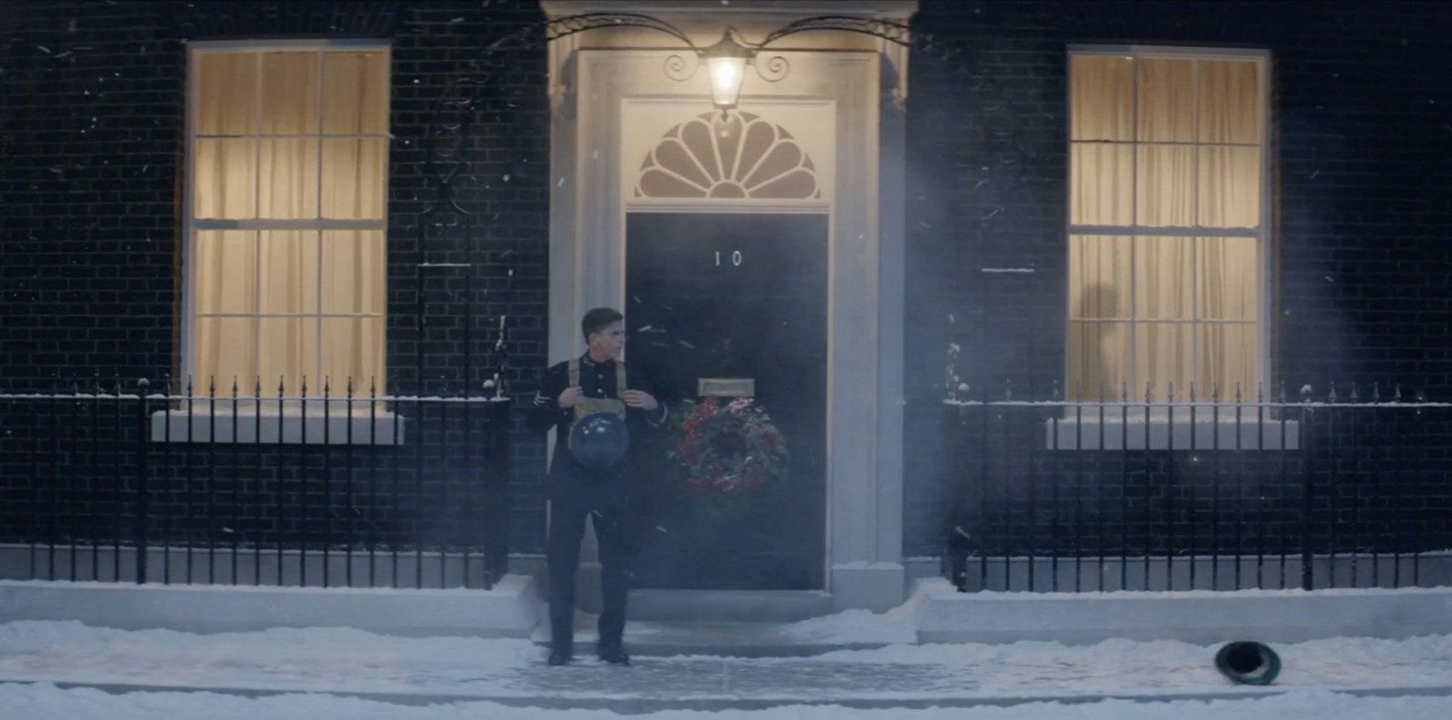 a man standing in front of a black door