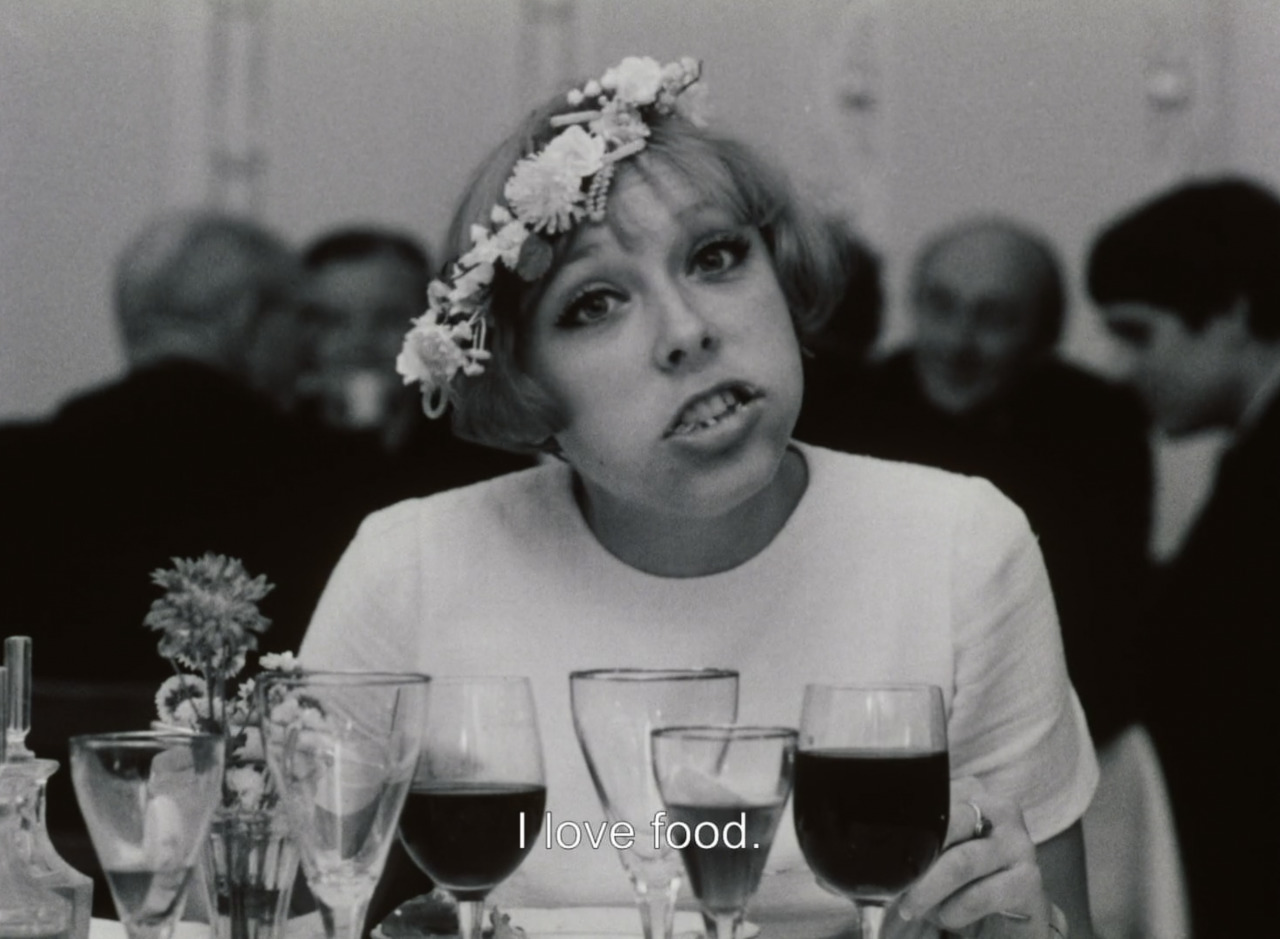 a woman sitting at a table with glasses of wine