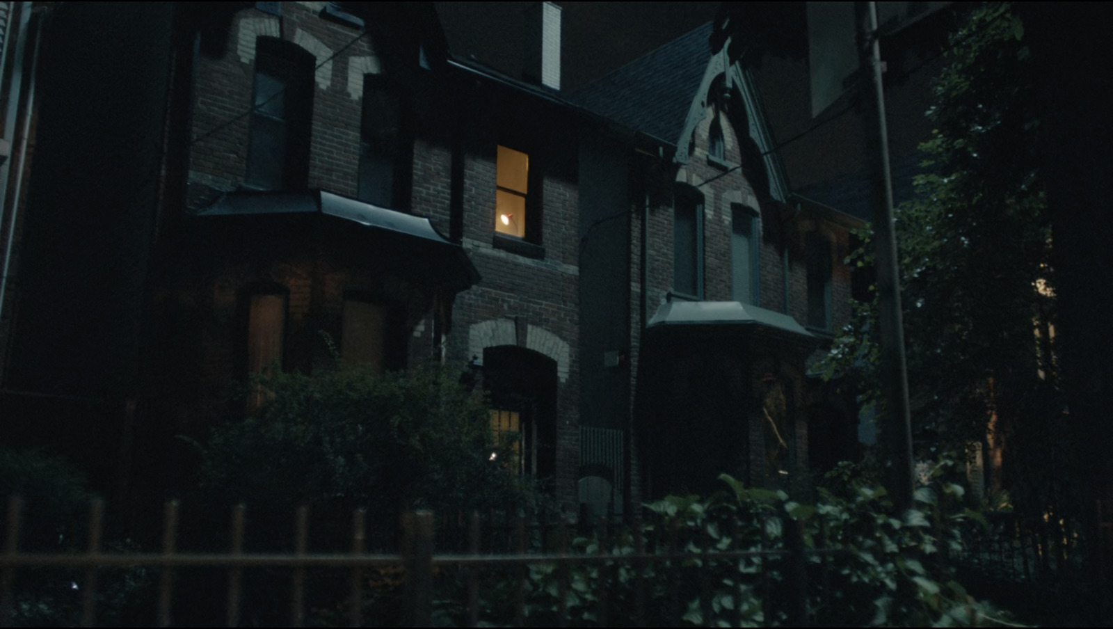 a creepy looking house with a cross on the roof