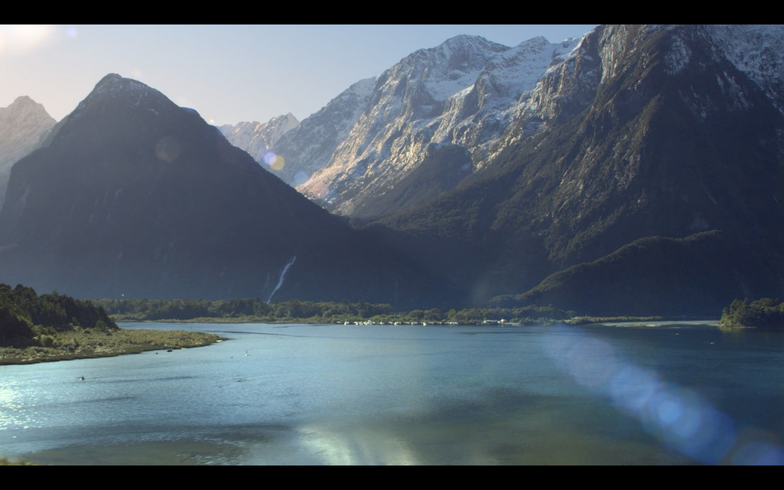 a view of a river with mountains in the background