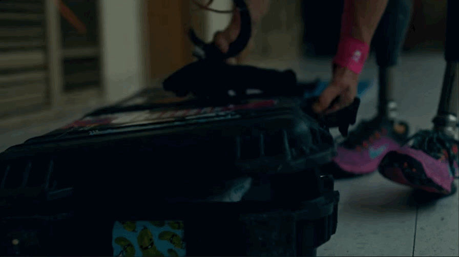 a person standing next to a piece of luggage