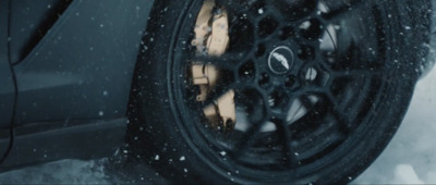 a close up of a tire on a car in the snow