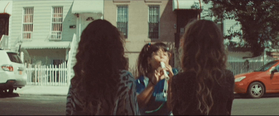 a group of women standing next to each other on a street