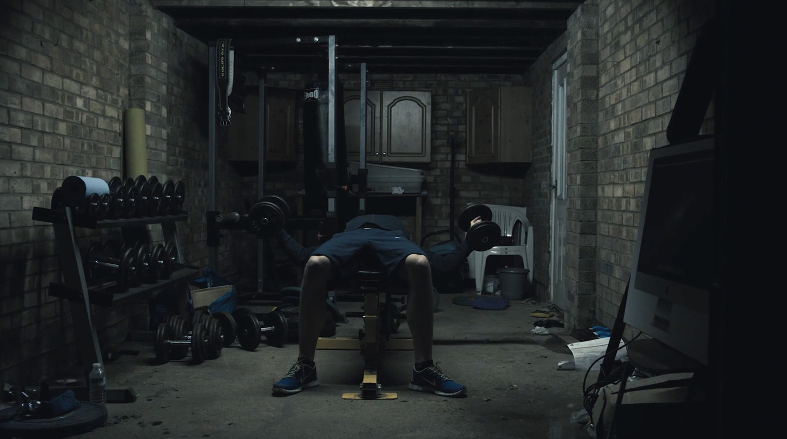 a man sitting on a stool in a room