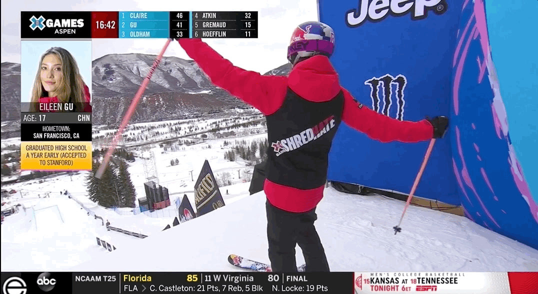 a person in a red and black jacket on skis