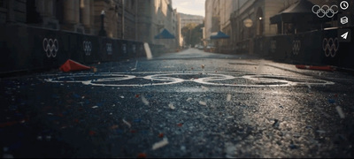 an olympic symbol is shown on a wet street