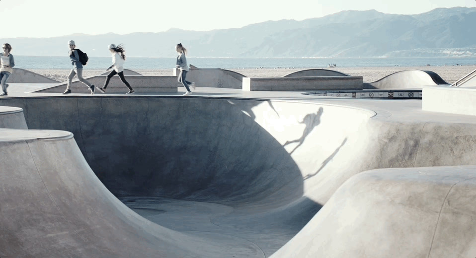 a group of people riding skateboards at a skate park