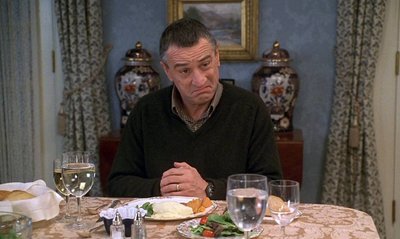 a man sitting at a table with a plate of food