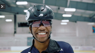 a smiling man wearing a helmet and goggles