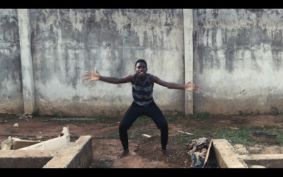 a man standing in front of a cement wall