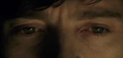 a close up of a man's eyes with a blurry background