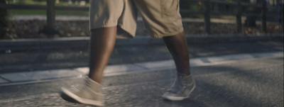 a person walking down a street with a skateboard