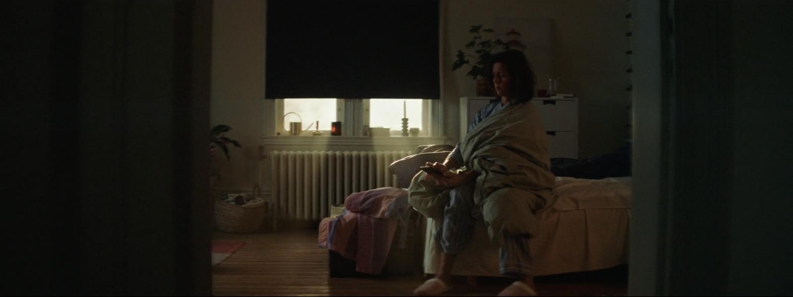 a woman wrapped in a blanket standing in a room