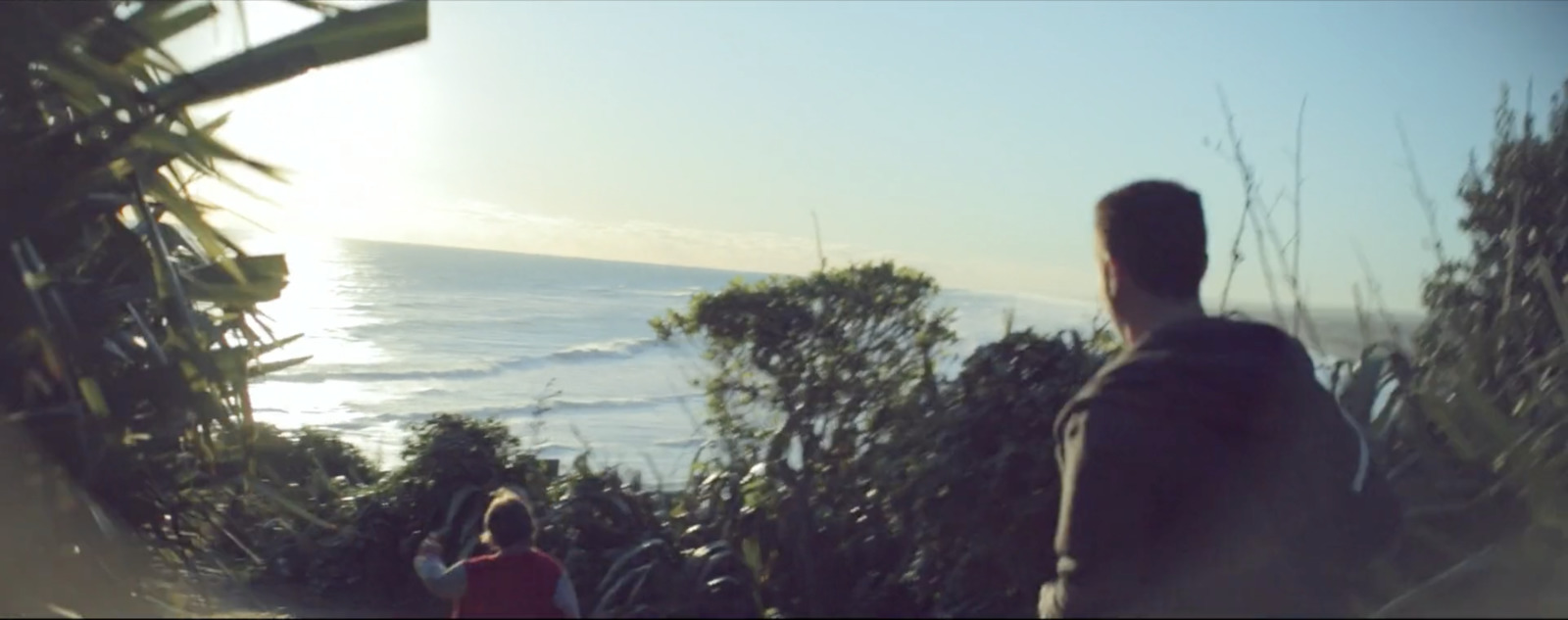 a couple of people standing on top of a hill