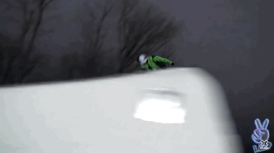 a person riding a snowboard down a snow covered slope