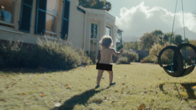 a little boy that is standing in the grass